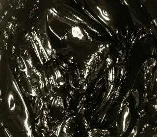 Close-up of black plastisol ink for screen printing, showcasing its glossy and thick texture.