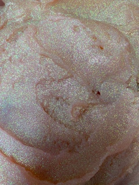 Close-up of shimmering pink glitter plastisol ink with a metallic shine, ideal for screen printing on various fabrics.