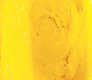 Swirling golden yellow plastisol ink, ideal for screen printing on various fabrics.