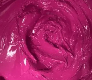 Close-up of neon magenta plastisol ink, showcasing its glossy texture perfect for screen printing on fabrics.