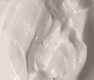 Close-up of Soft Flash White plastisol ink with a creamy texture, ideal for screen printing. Phthalate free, made in the UK.