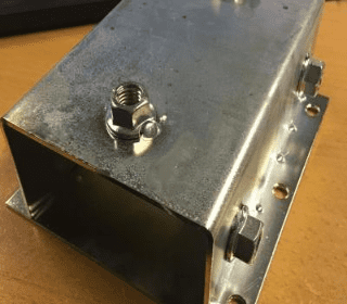 Steel bracket for mounting printing boards, includes bolt and hole for secure attachment.